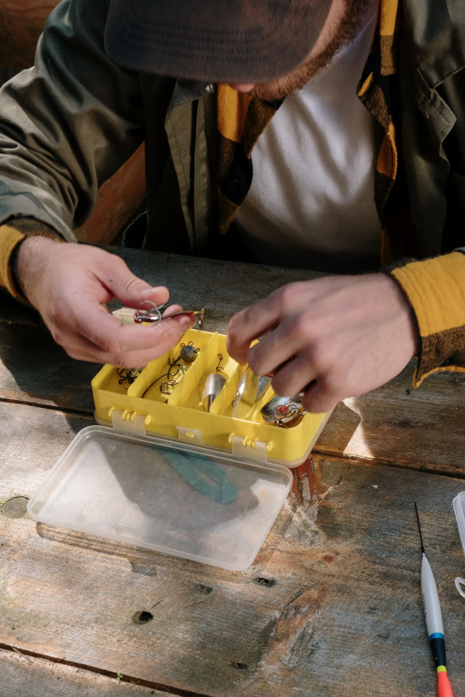 Hands preparing fishing tackle
