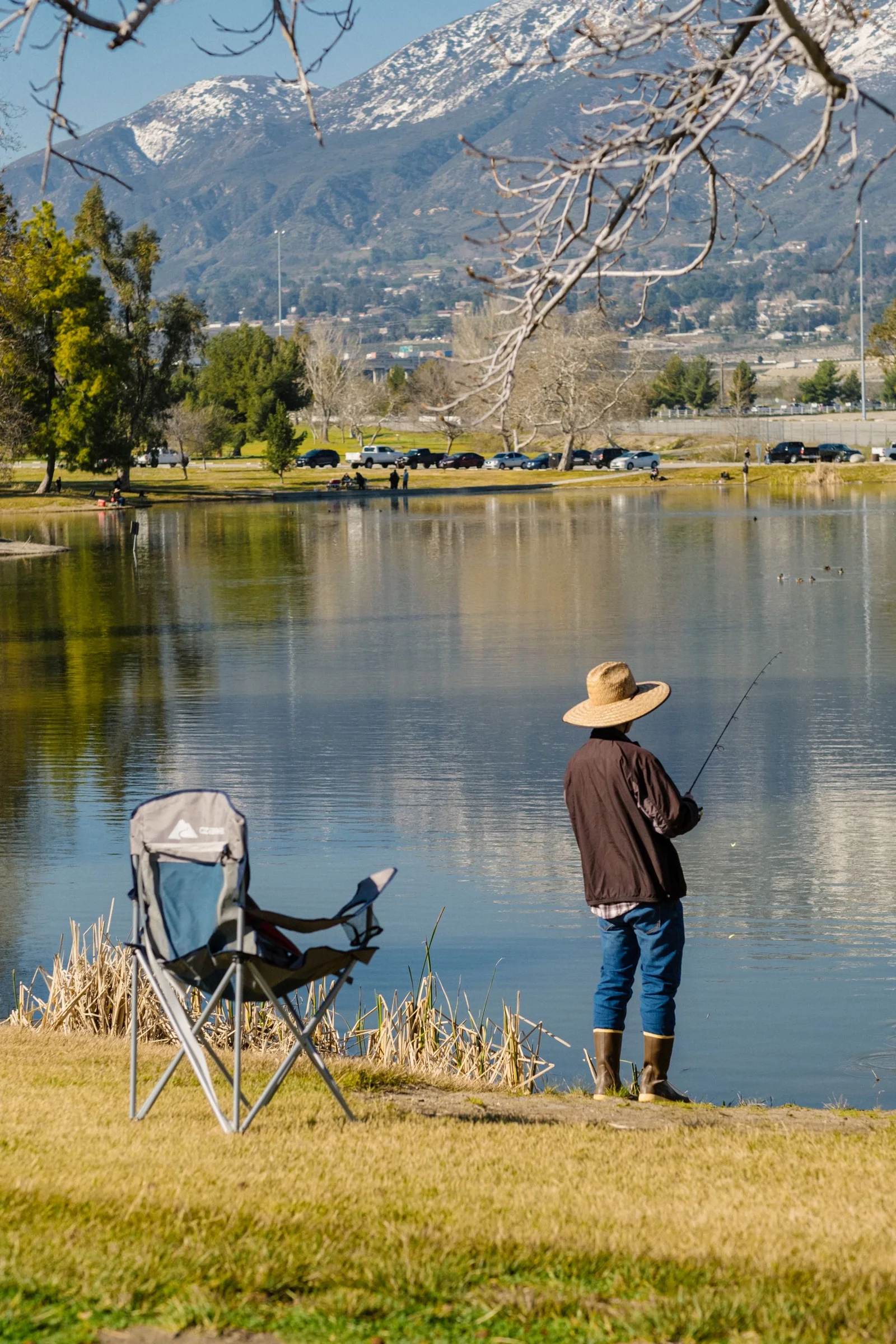 Fishing rod held near a mountain lake
